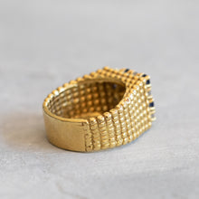Load image into Gallery viewer, Side profile view of the 18k yellow gold ring showing the thick polished sizing bar and the transition to the beaded granulated texture.