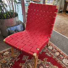 Load image into Gallery viewer, Front view of a signed Knoll Jens Risom lounge chair with woven tomato red cotton webbing.