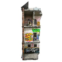 Load image into Gallery viewer, Cutaway view of mixed media architectural sculpture with exposed interior rooms and graffiti-covered walls.