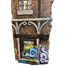 Load image into Gallery viewer, Close-up of lower facade with window panel labeled “378,” graffiti, and textured brick surface.