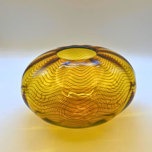 Load image into Gallery viewer, Angled view of amber glass vase by Sam Stang with organic shape and detailed black line decoration.