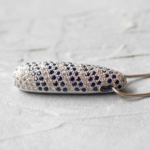 Load image into Gallery viewer, Close-up of sapphire and diamond pendant on 14K gold necklace, horizontal side view