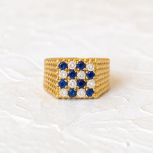 Load image into Gallery viewer, 18k gold diamond and sapphire checkerboard ring on a cream plaster background

