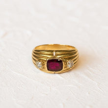 Load image into Gallery viewer, 18k gold ruby and diamond ring on a cream plaster background
