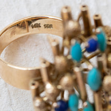 Load image into Gallery viewer, Close-up of the 14k gold hallmark and maker's mark on the interior of the turquoise and lapis ring band.
