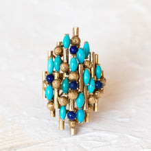 Load image into Gallery viewer, Front view of a 14k gold statement ring featuring a cluster of turquoise and lapis lazuli gemstones.
