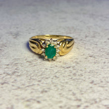 Load image into Gallery viewer, A 14K gold band ring with emerald and diamond embellishments.

