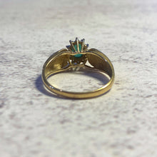 Load image into Gallery viewer, Underside of 14K gold emerald and diamond ring showing band interior and setting
