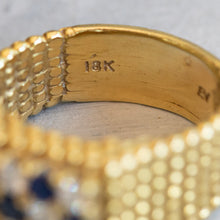 Load image into Gallery viewer, Close-up of the 18k gold hallmark stamped on the interior of the polished yellow gold band.

