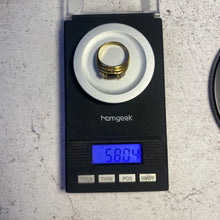 Load image into Gallery viewer, 18k gold ruby and diamond ring on a digital scale showing the total gram weight.

