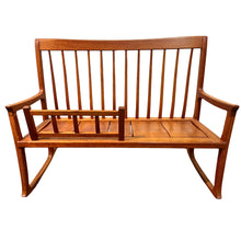 Load image into Gallery viewer, Wood rocking bench by Larry Hepler with slatted back, sculptural arms, and clean contemporary lines in a natural wood finish.
