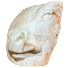 Load image into Gallery viewer, Full view of “Bovine Emerging” alabaster sculpture by Carolyn Brandt showing carved bovine form with natural orange and cream veining.
