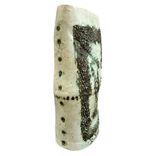 Load image into Gallery viewer, Side view of glazed stoneware vase showing incised dotted edge and raised textured figural panel.
