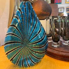 Load image into Gallery viewer, Murano art glass vase by Orlando Zennaro with blue and black feathered pattern displayed on a wooden surface with glassware and decor in the background.
