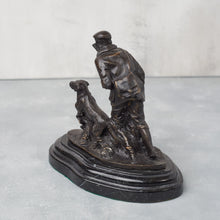 Load image into Gallery viewer, Back view of bronze hunter and dog, showing figure detail and surface patina.
