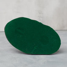 Load image into Gallery viewer, Underside of sculpture showing green felt covering on the base.
