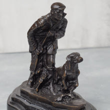 Load image into Gallery viewer, Front three-quarter view of bronze hunter and dog with dark patina, showing figure detail and expression.
