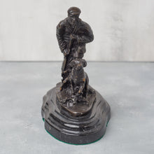 Load image into Gallery viewer, Front view of bronze hunter and dog, showing facial detail and forward stance.
