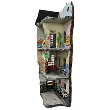 Load image into Gallery viewer, Angled view of fragmented building facade with layered floors, weathered surfaces, and graffiti markings.
