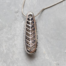 Load image into Gallery viewer, Underside of 14K gold sapphire and diamond pendant necklace showing openwork setting and stone placement
